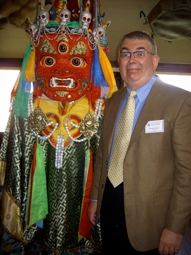 Dr. Shelly enjoying the colorful figure on a trip to China