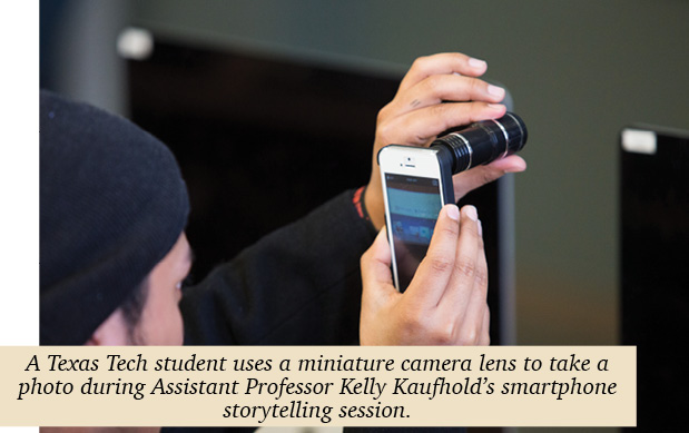 A student holding a mini lens up to his iPhone