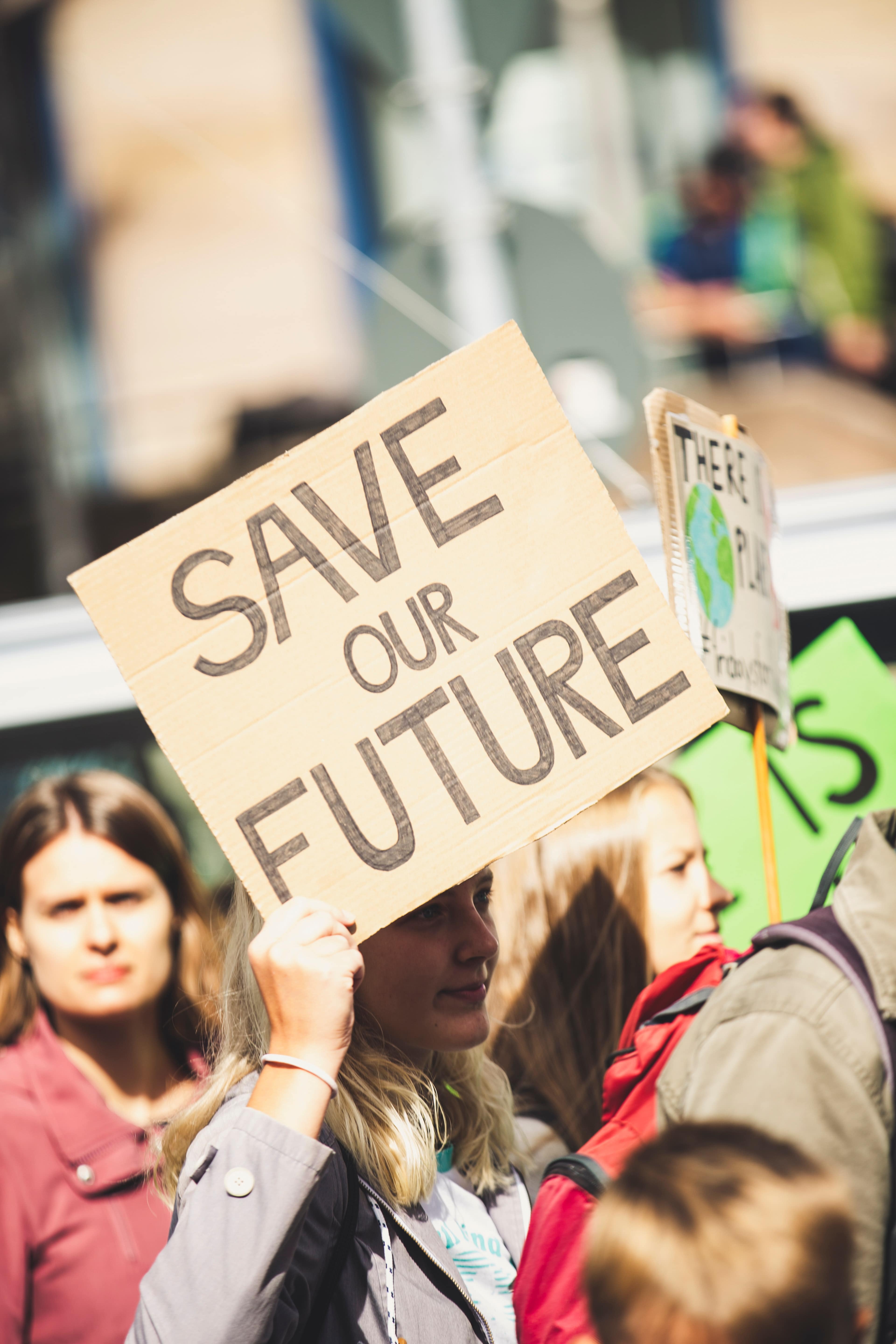 Protester with sign that states "Save Our Future"