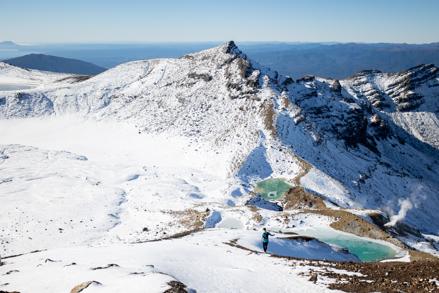 snowy mountain with person on the peaks