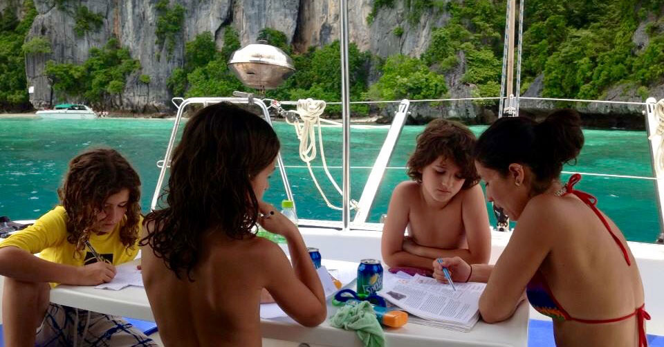 The Alexander family studying aboard TRIBE.