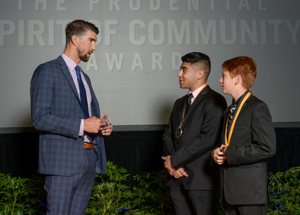 Olympian Michael Phelps recognizes Ryan and friend Micah for their charitable endeavors at the Prudential Spirit of Community Awards.
