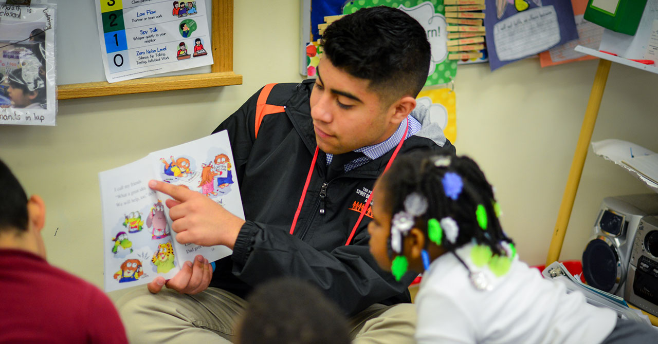 Ryan Almusawi reads to an elementary student at a school in Washington D.C.