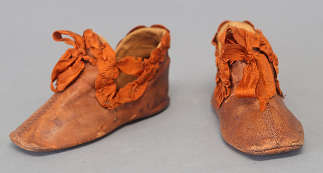 Child’s Brown Leather Shoes with Orange Ribbon Trim and Ties, c 1830s, Gift of L. Jean and Rebecca Wallace, TTU-H2017-030-070