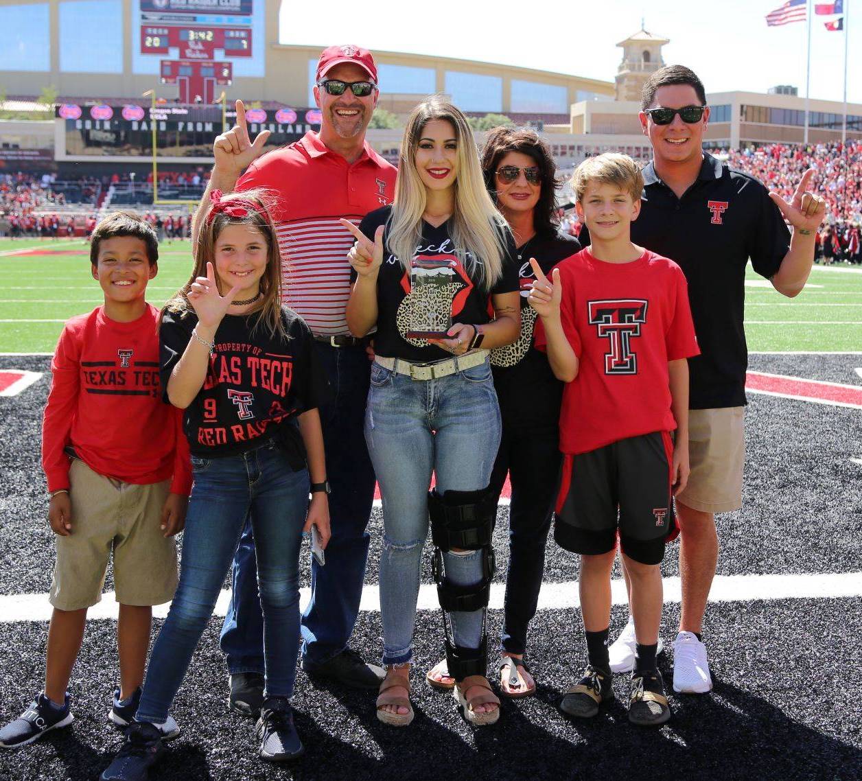 Parents of the Year awarded plaque during the Family Weekend football game