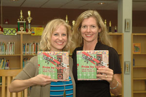 pantoya and hunt holding books in library