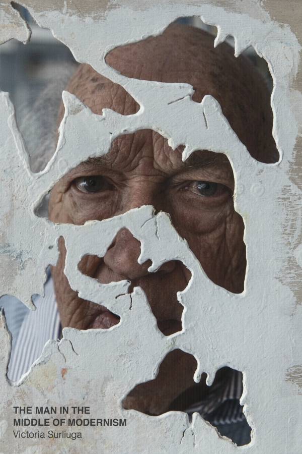 man staring through plaster butterfly cutouts