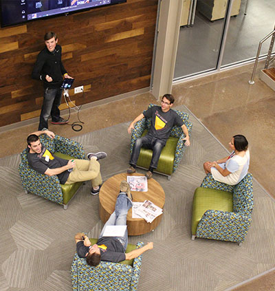 students meeting in innovation hub lobby during 3 day startup