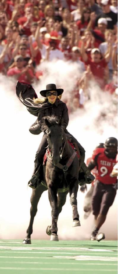 The Masked Rider on her horse race down the field.