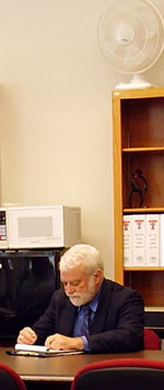 President John Howe reading an important document