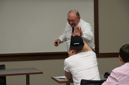 Texas Tech Professor high fives student in class.