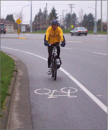 man on bicycle in bike lane