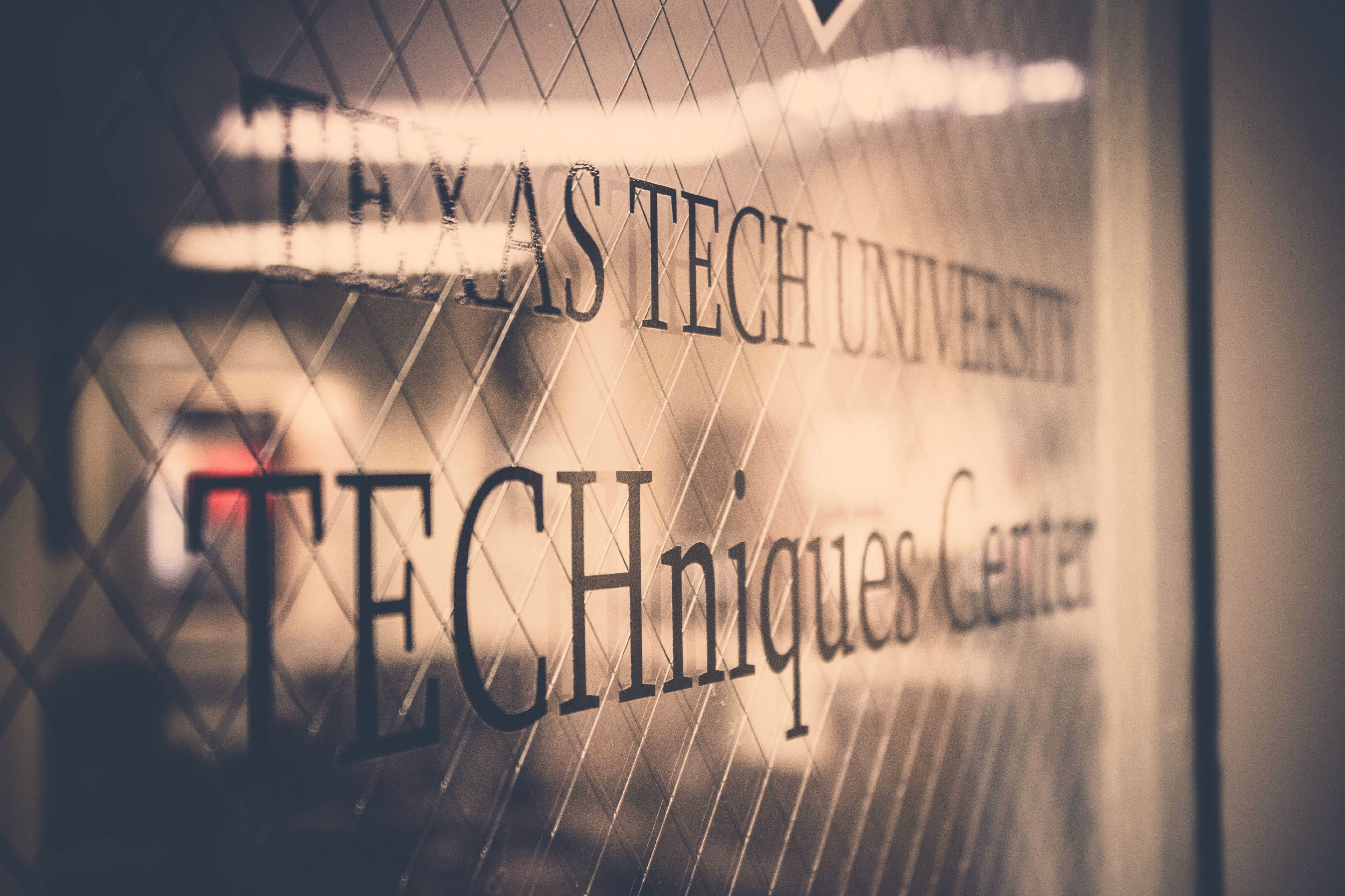 Close up of glass window a the front door of Texas Tech University's TECHniques Center