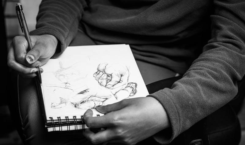 TCVPA student sketching on a sketch pad visual performing arts