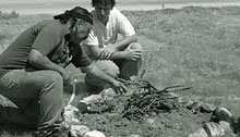 Volunteers building a campfire