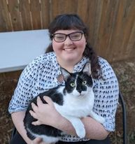 Female holding cat.