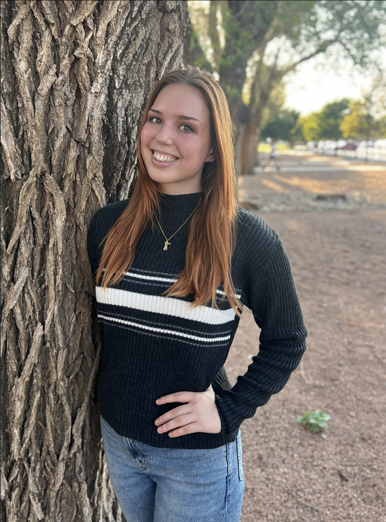 girl posing by tree