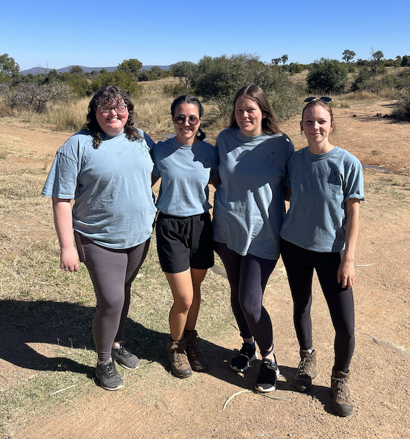 four females standing in a row