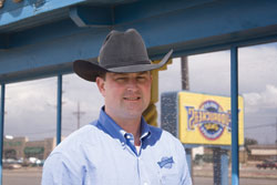 Daniel in front of Fudruckers sign