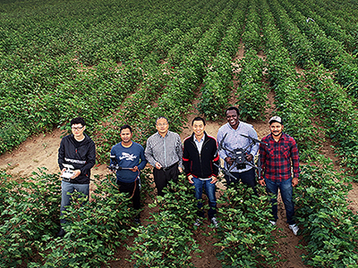 Wenxuan Guo group in field with drones
