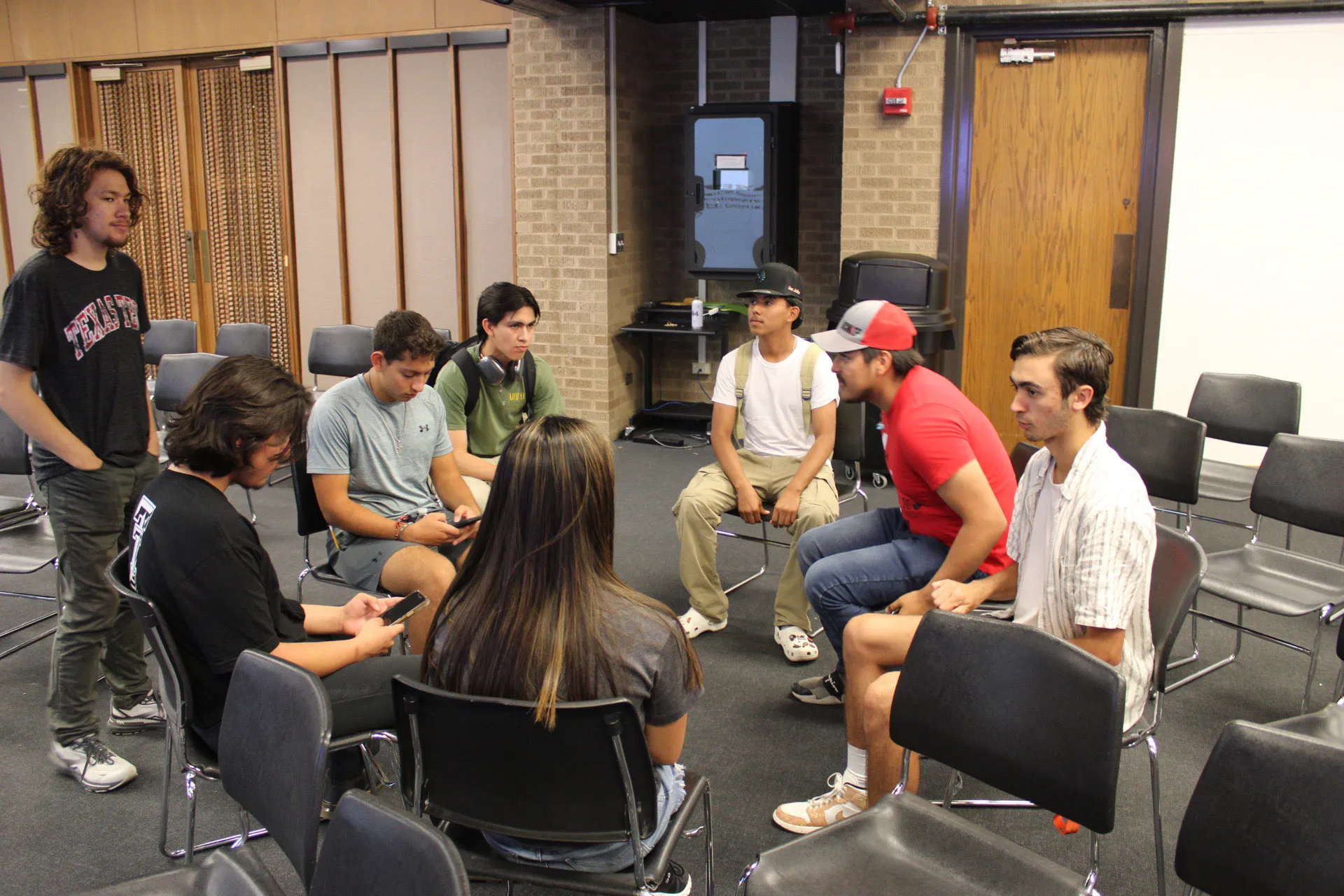 Studio Hacks students sitting in a group having a discussion