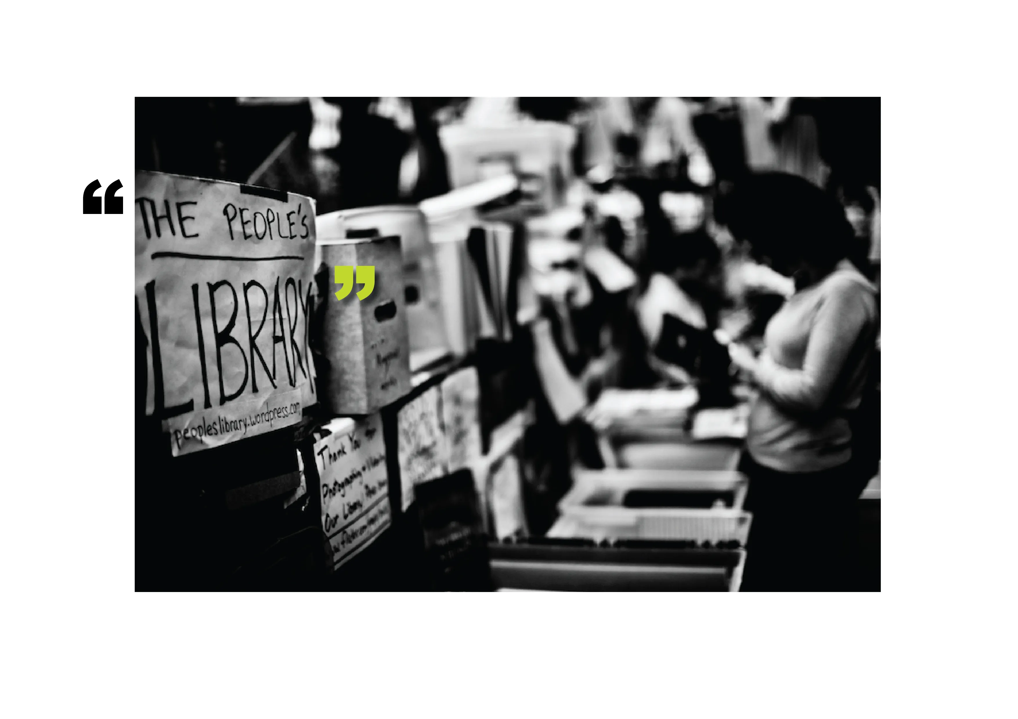 Black and white photo of The People's Library. A person in the background looking through a book.