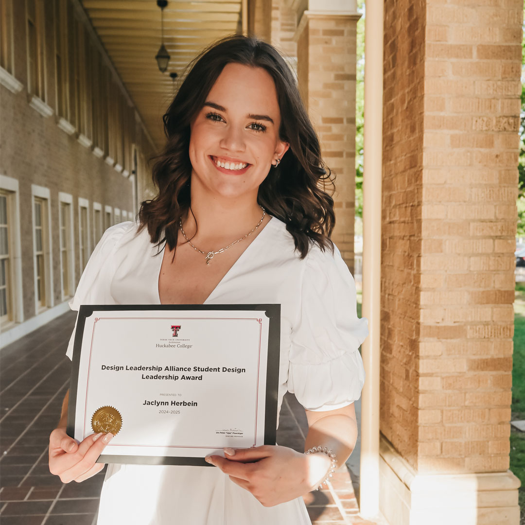 Headshot of Jaclynn Herbein holding the Student Design Leadership Award certificate.