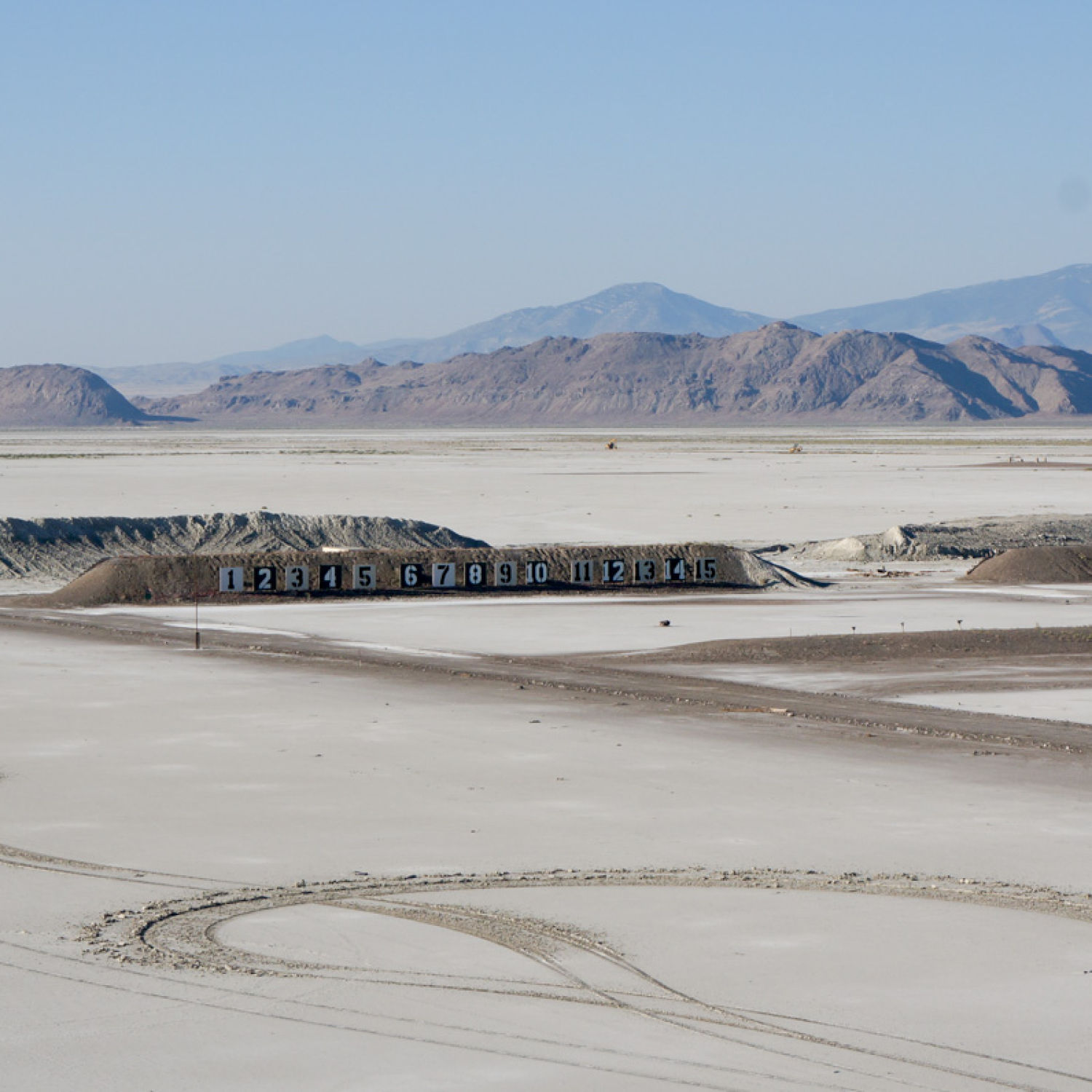 Outdoor dirt race and rally track, with mountain view in background.
