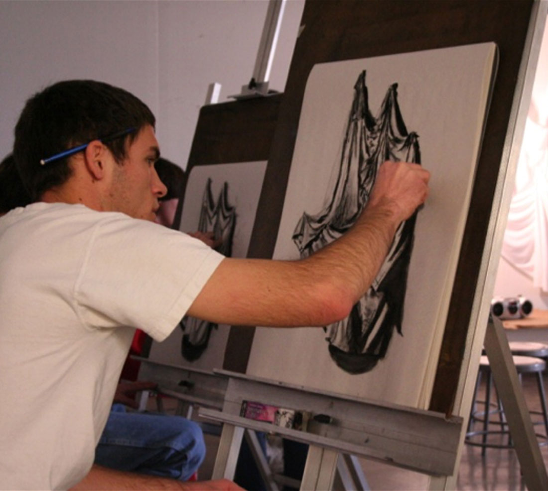 Student painting in workshop