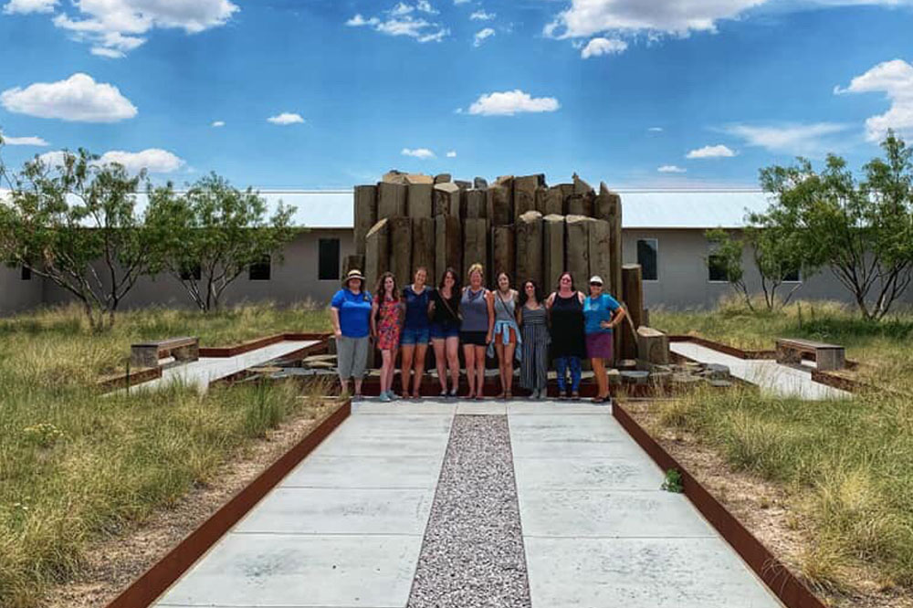 Group Standing in front an outdoor art piece