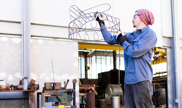 TTU art student working on metal scultpture