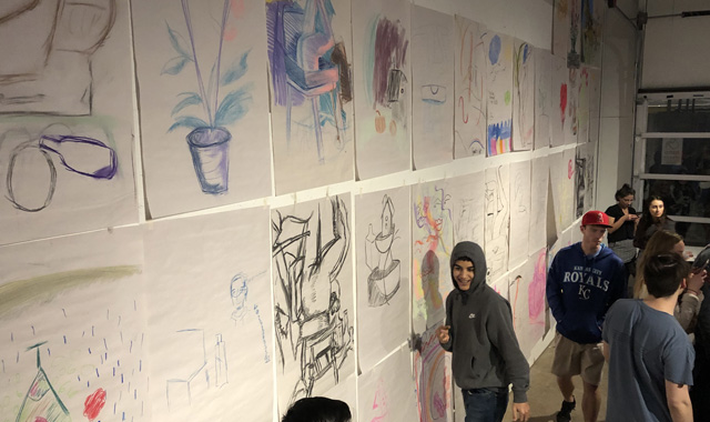 Students viewing art on a wall