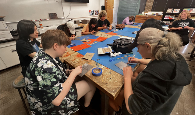 Pre-college immersion students working on a project