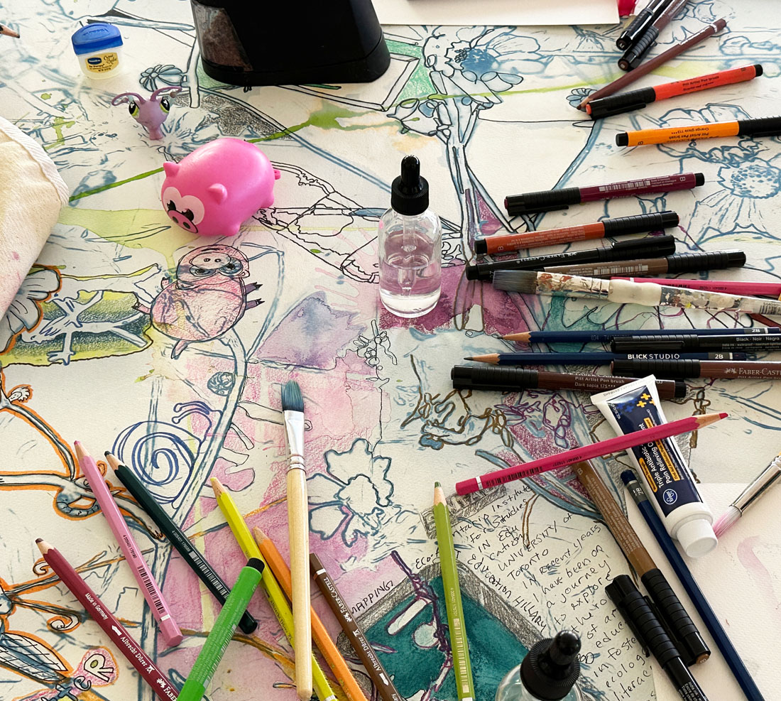 Paper on a table with multiple paint brushes