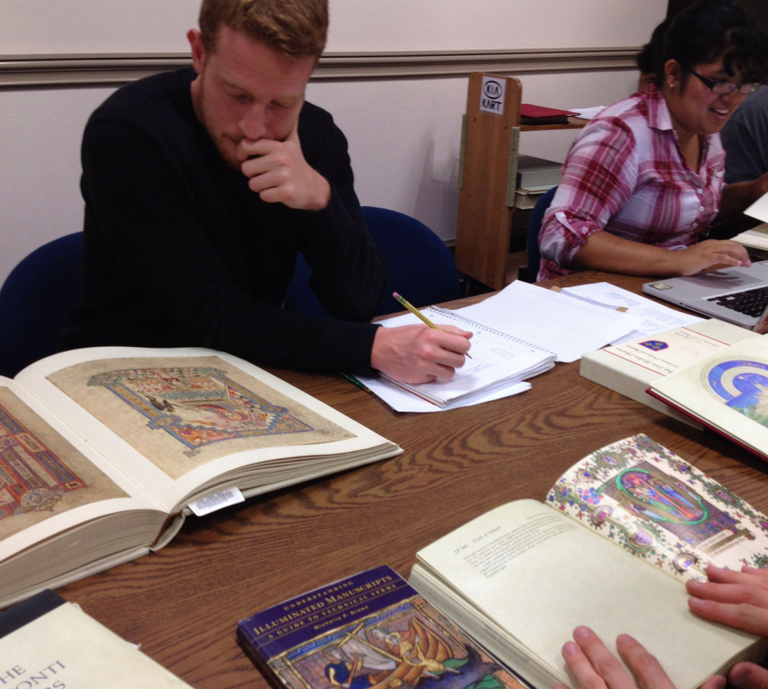 Students looking at art in books