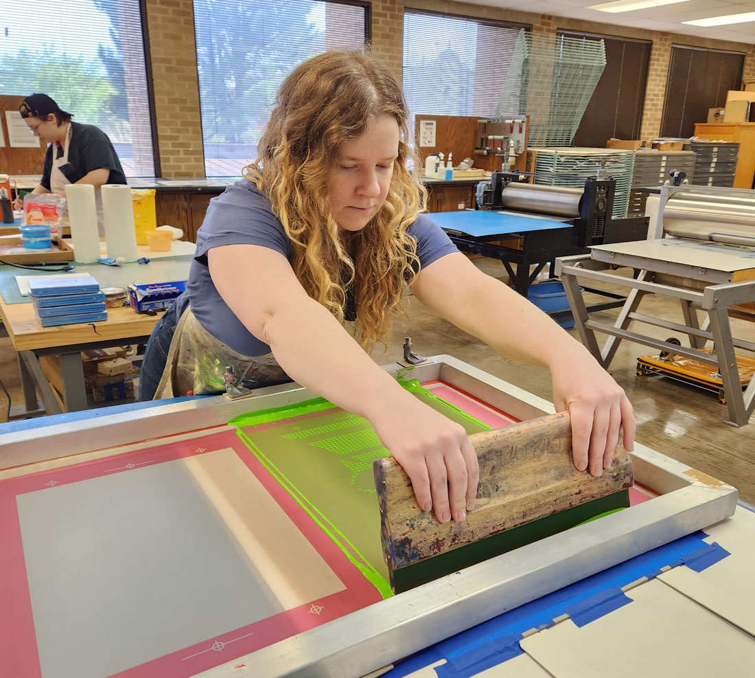 School of Art student using printmaking equipment