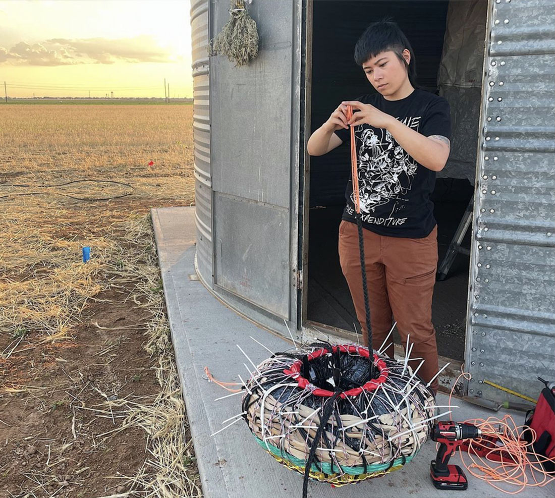 SOA student in a field working on an art piece