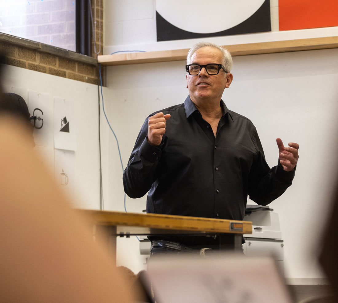 Speaker in classroom with art students