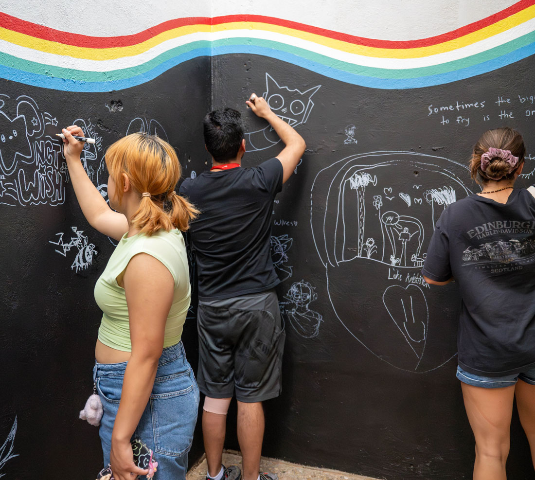 TTU art students drawing on a wall