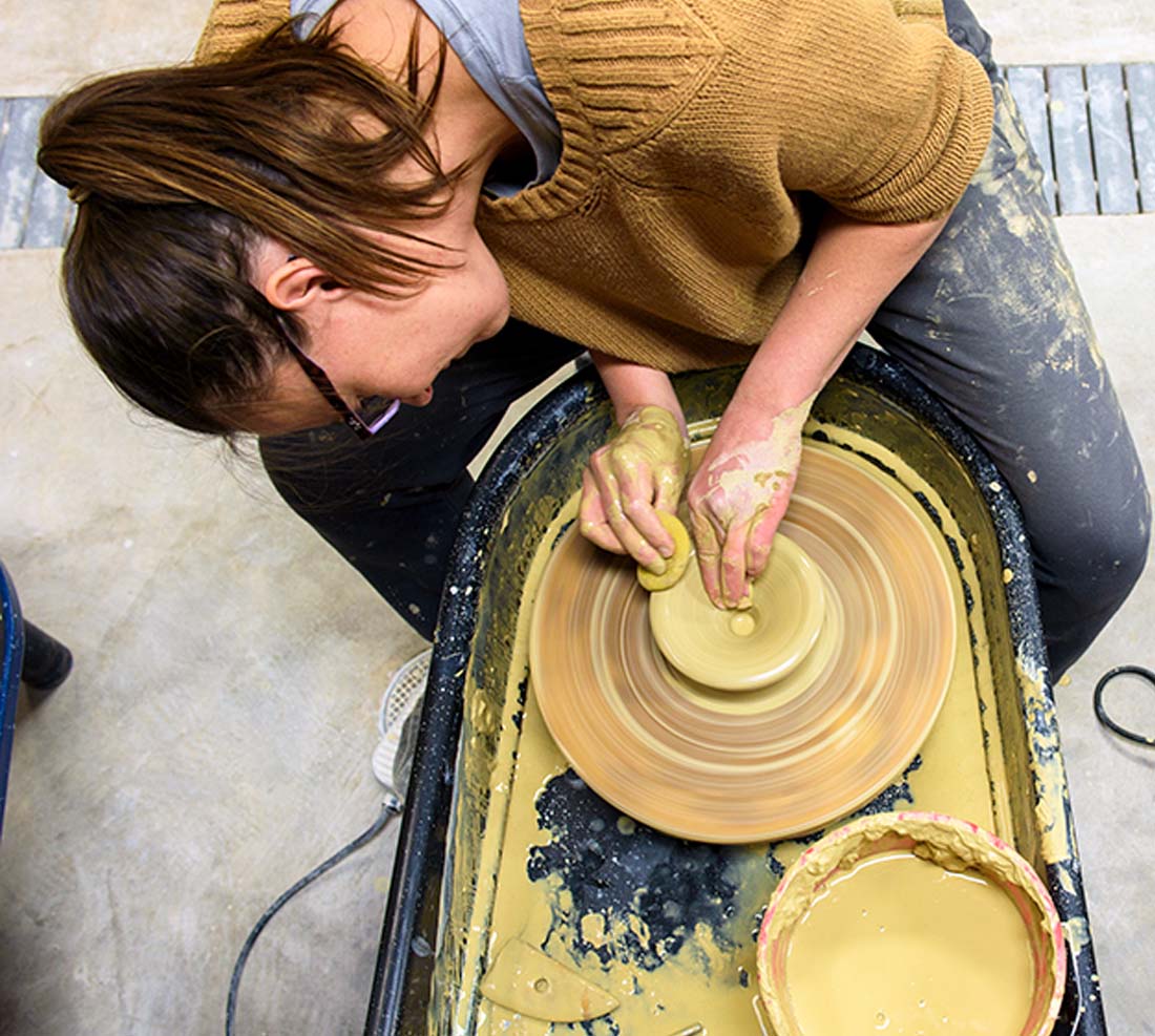 TTU student sculpting pottery