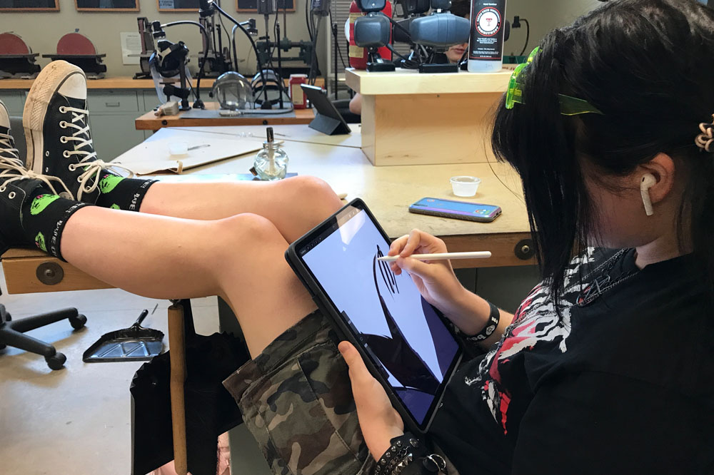 Student drawing on a tablet