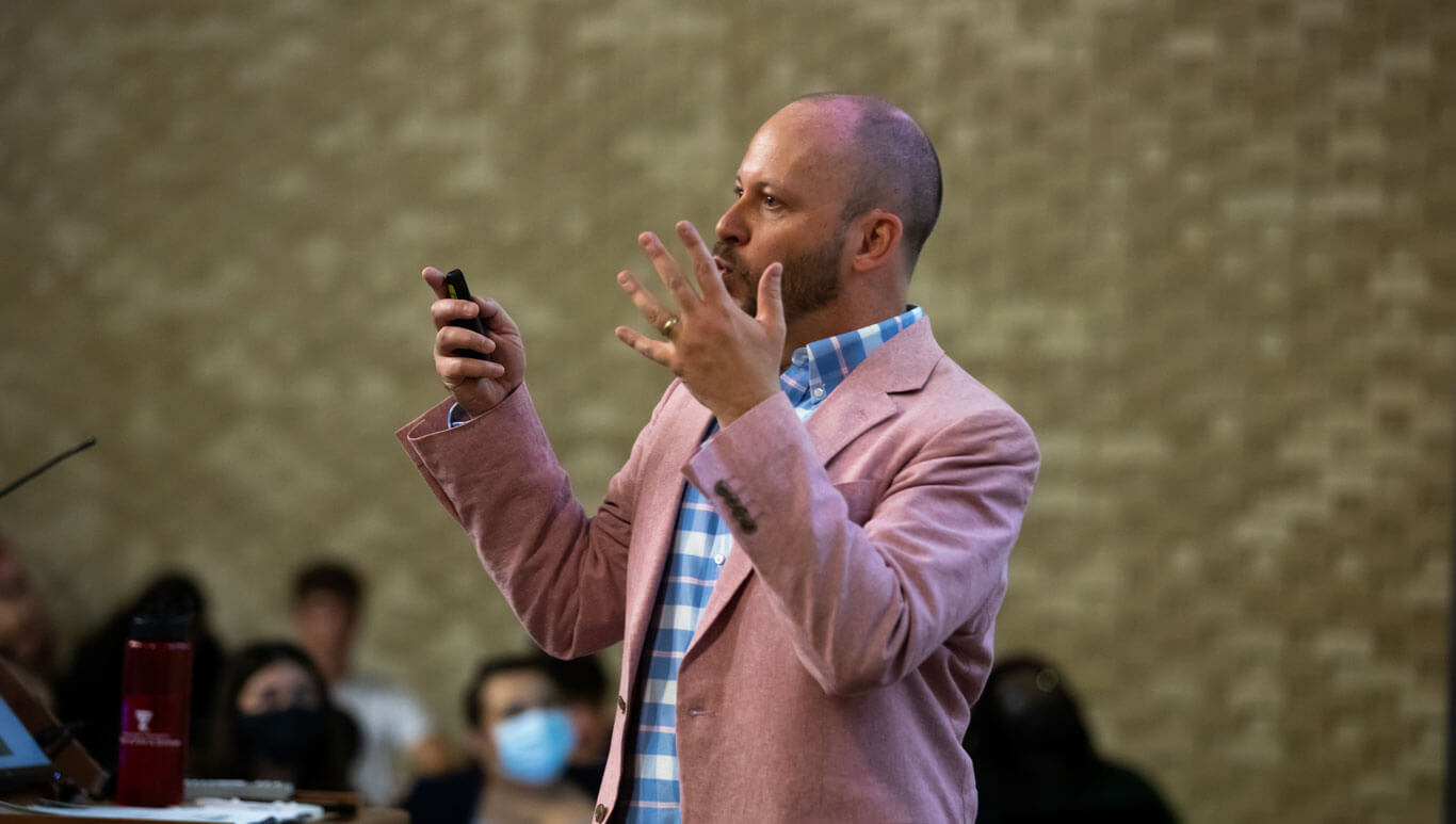 associate dean sean cunningham talking at a podium