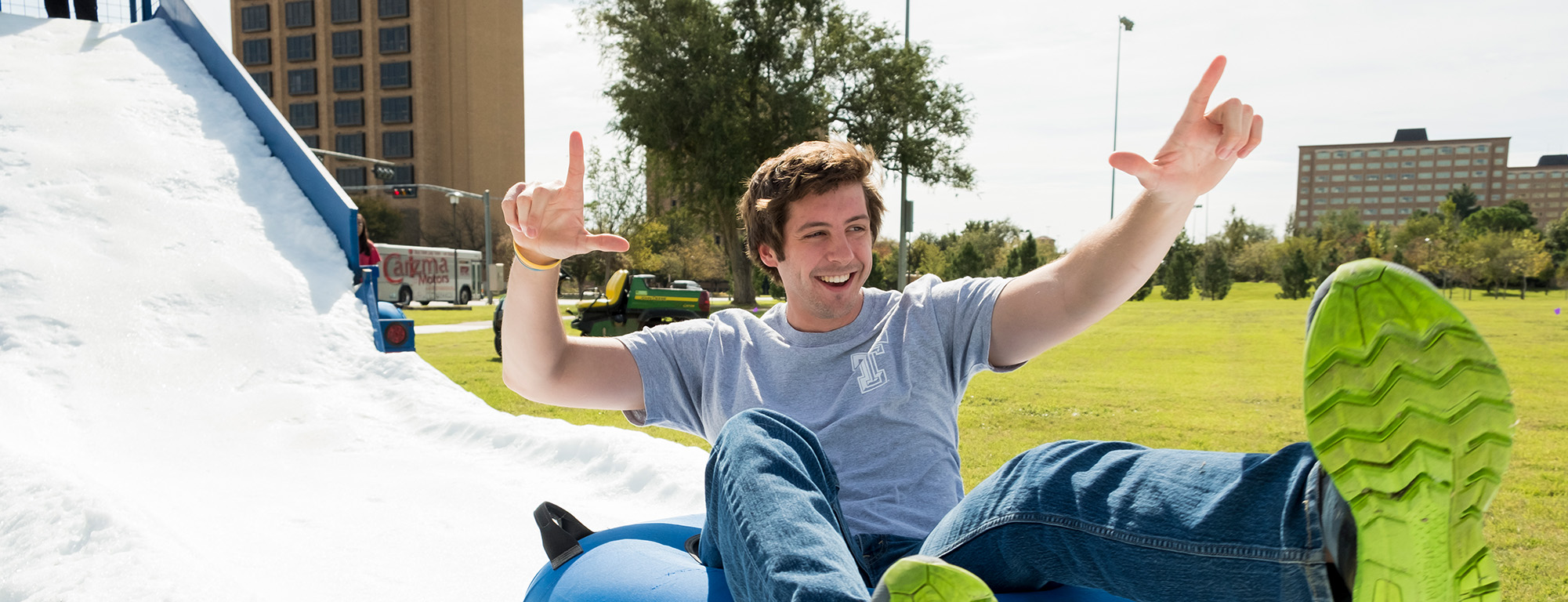 student sliding down foam slide