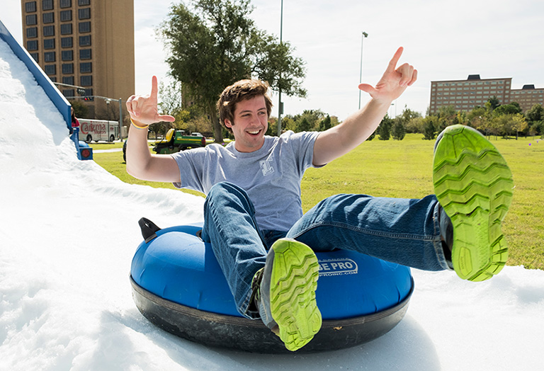 Texas Tech University students sliding down a foam slide