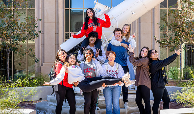 Texas Tech students sliding down a foam slide on an inner tube
