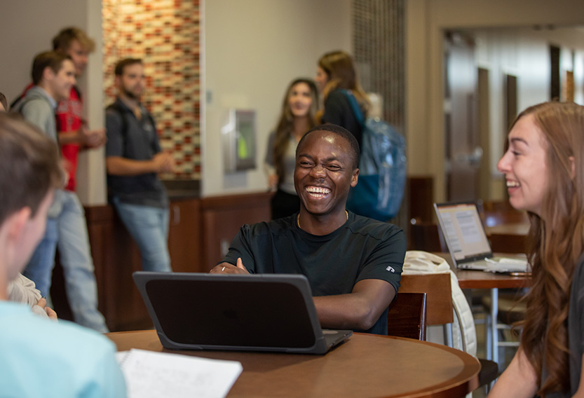 Texas Tech University students sitting at a table smiling