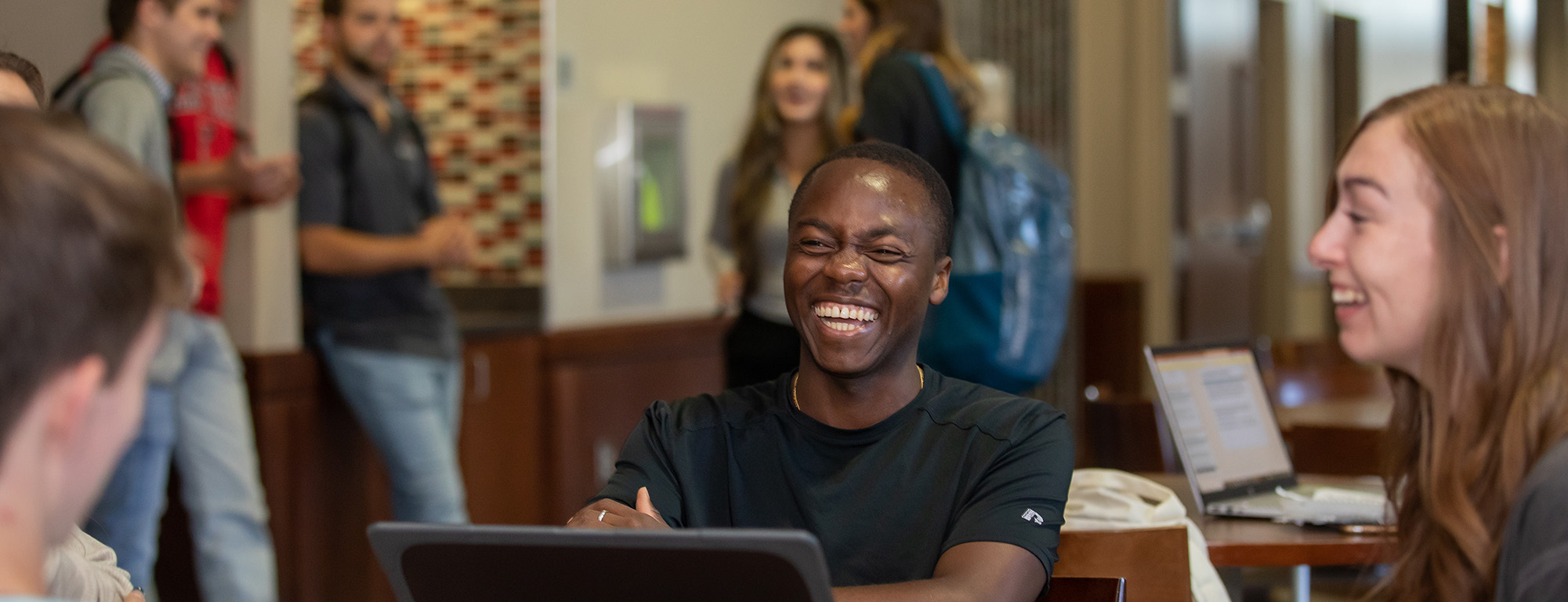 students at a table sharing a laugh