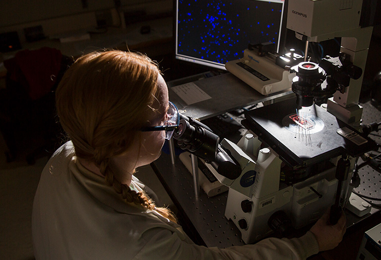 scientist using microscope