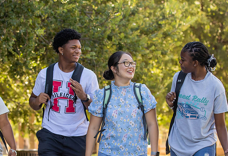 students walking holding books