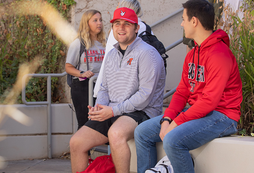 Texas Tech university students sitting and smiling